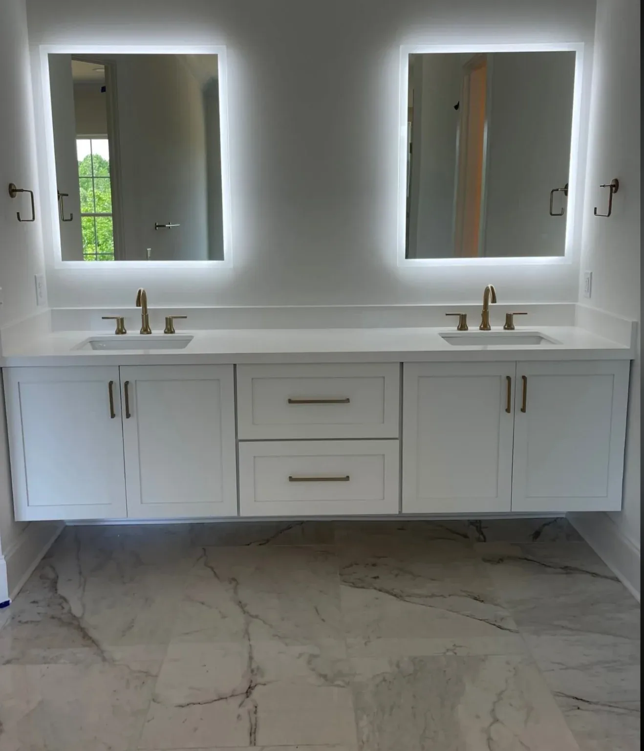 White double vanity with twin backlit mirrors