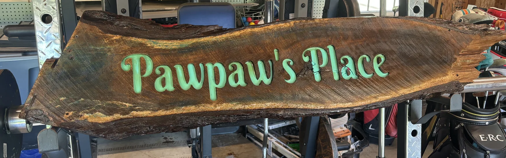 Pawpaw’s Place sign carved into a live-edge piece of timber
