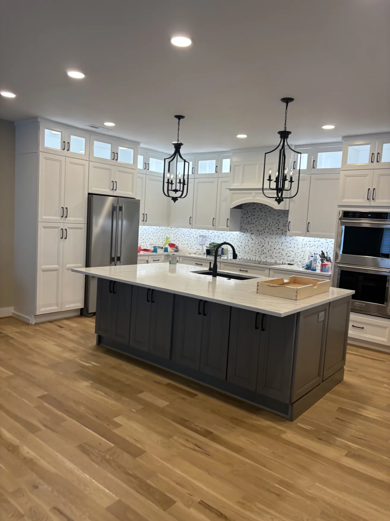 Large kitchen with pale cabinetry and gray fitted island
