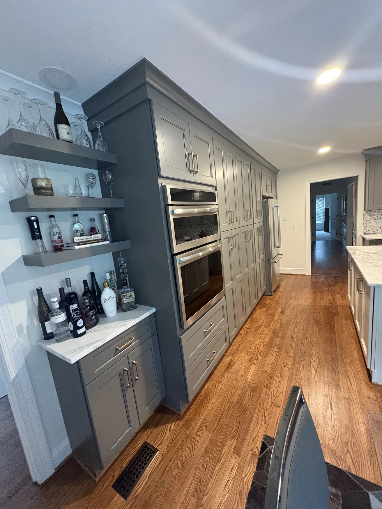 Full-height built-in appliance wall with paneled cabinetry