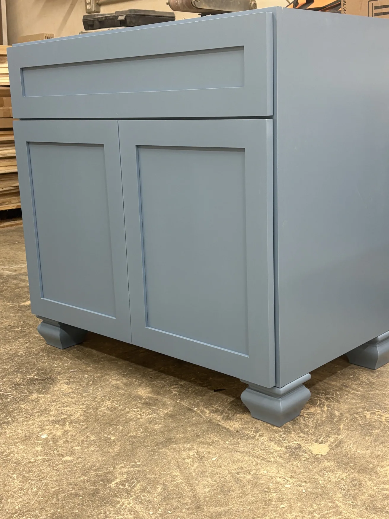 Freshly built slate-colored cabinet with carefully aligned doors in the workshop